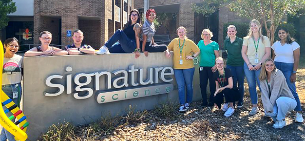 Photo of the Signature Science Forensic DNA team in front of the company headquarters building in Austin Texas.