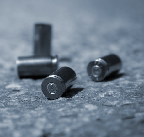 Photo of 4 shell casing on the ground
