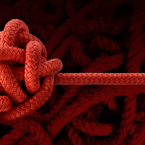 Jumbled knot with a single strand emerging to the right