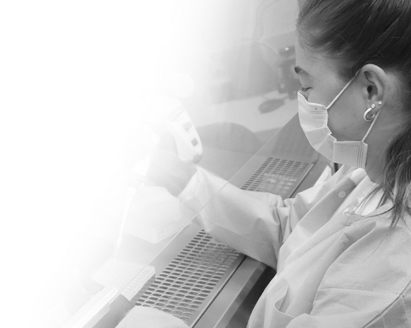 Lab technician at a hooded workstation