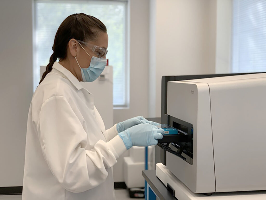 Masked lab technician working with samples
